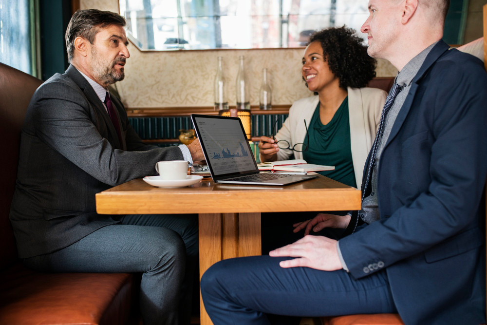 Attorney explaining contract terms to business professionals in California during a legal consultation.