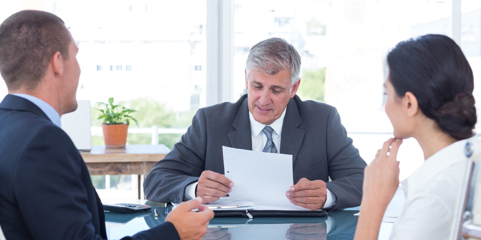 employment-agreements-nevada-california Employment attorney reviewing an employment agreement with an employer and employee in Nevada and California.