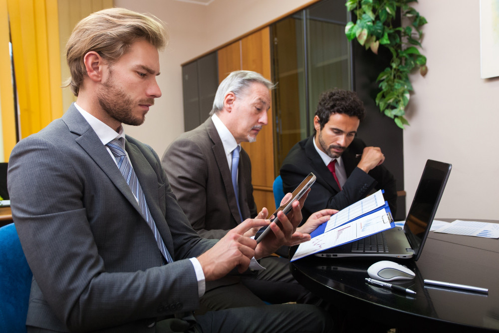 how-contracts-protect-businesses-and-individuals-nevada-california Business attorney reviewing contracts with clients in Nevada and California to protect legal interests.