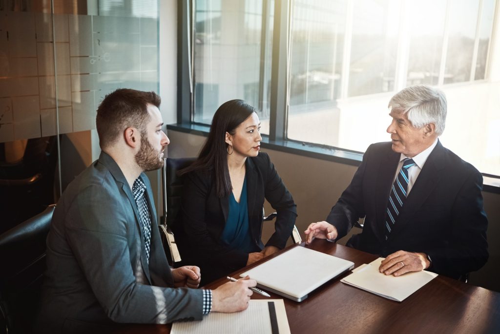 Business partners discussing a partnership dispute with a Nevada business attorney.