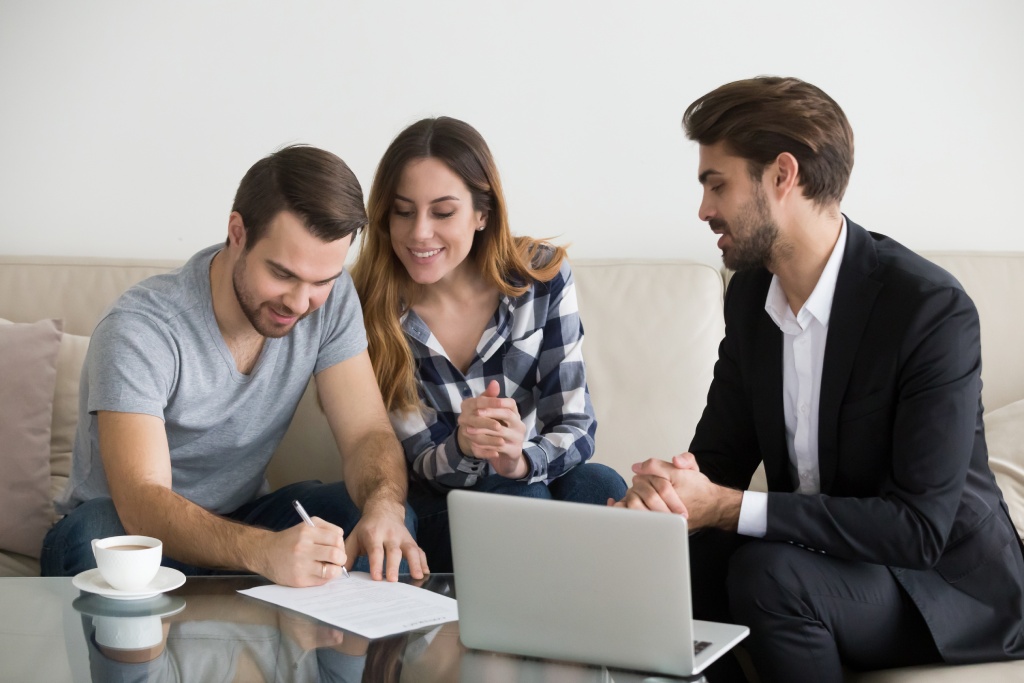 Buyers signing closing documents to complete a home purchase in Nevada.