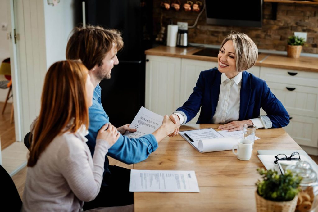 Buyer and seller reviewing a Nevada real estate purchase agreement before signing.