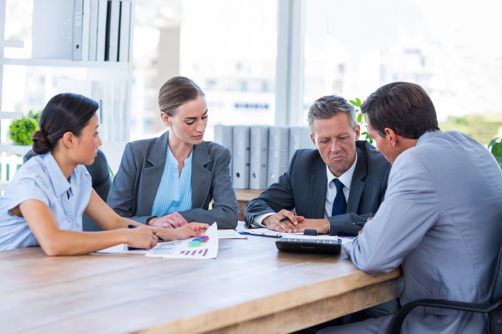 Management team discussing workplace policies and employee expectations during a business meeting.