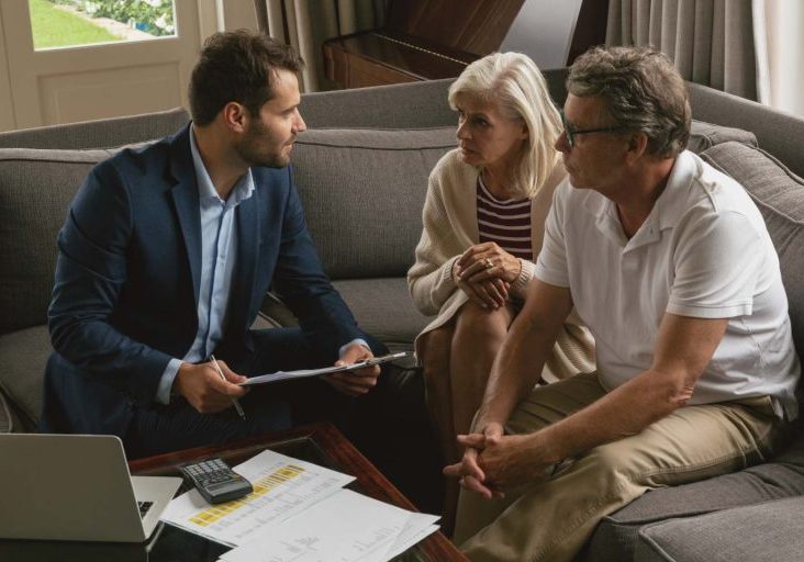 Family reviewing documents with a real estate attorney before buying a home in Nevada.
