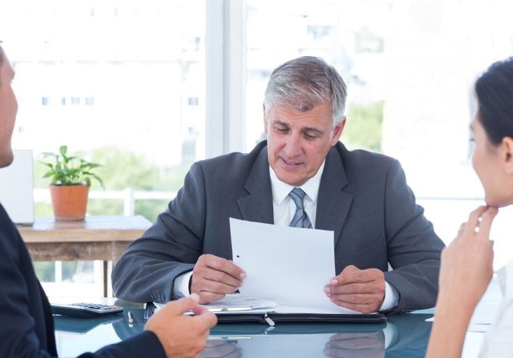 employment-agreements-nevada-california Employment attorney reviewing an employment agreement with an employer and employee in Nevada and California.