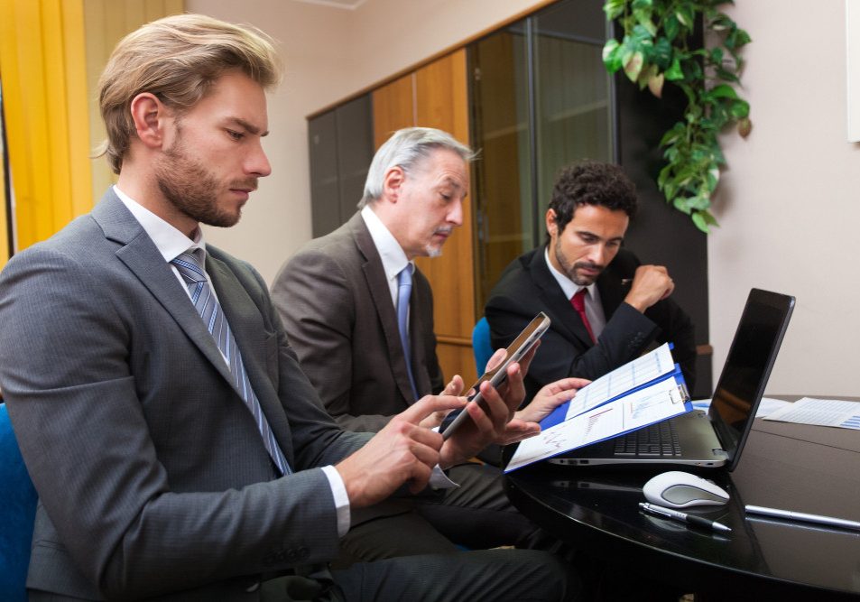 how-contracts-protect-businesses-and-individuals-nevada-california Business attorney reviewing contracts with clients in Nevada and California to protect legal interests.