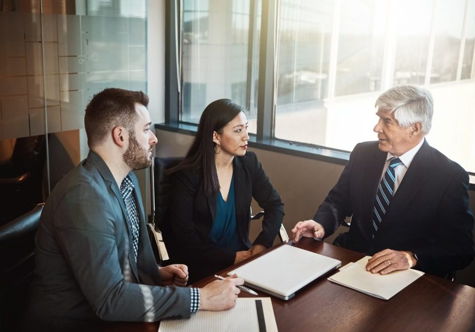 Business partners discussing a partnership dispute with a Nevada business attorney.