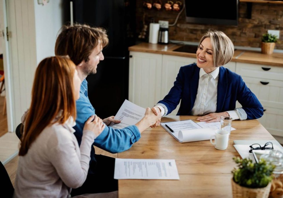 Buyer and seller reviewing a Nevada real estate purchase agreement before signing.